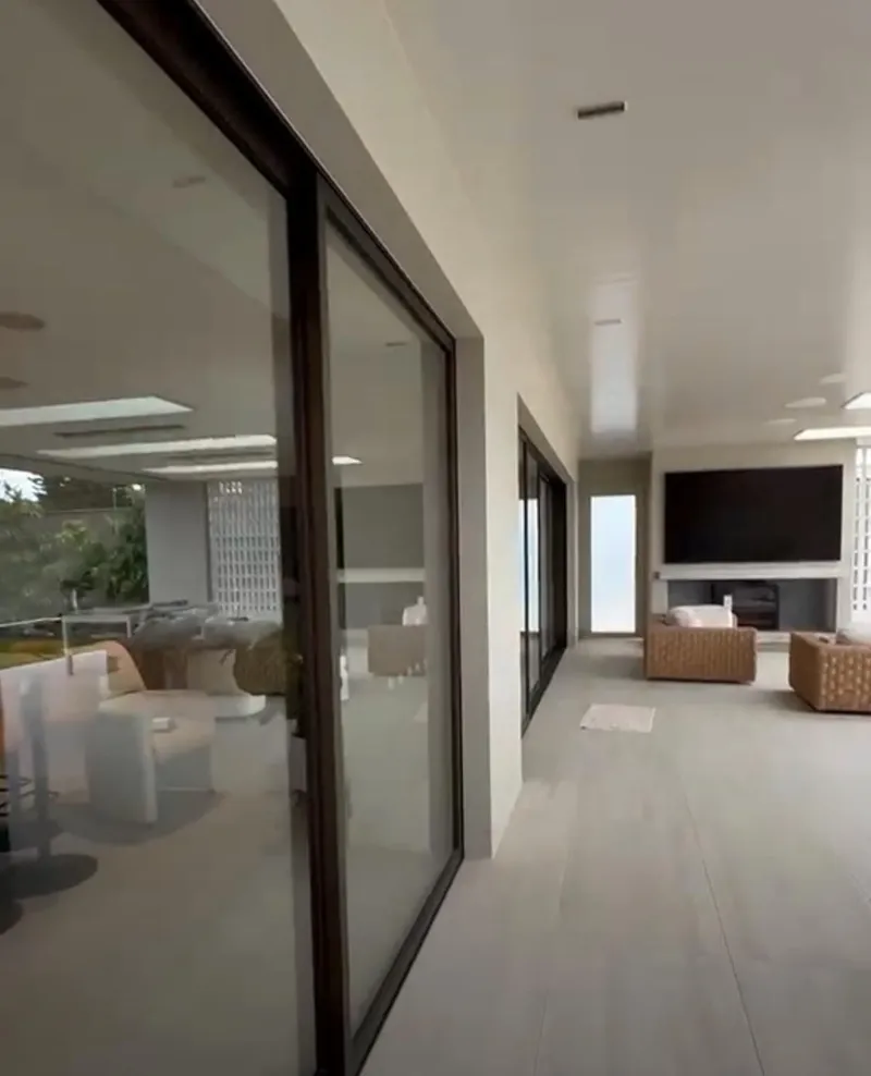 Covered alfresco area with painted walls and ceiling next to sliding doors