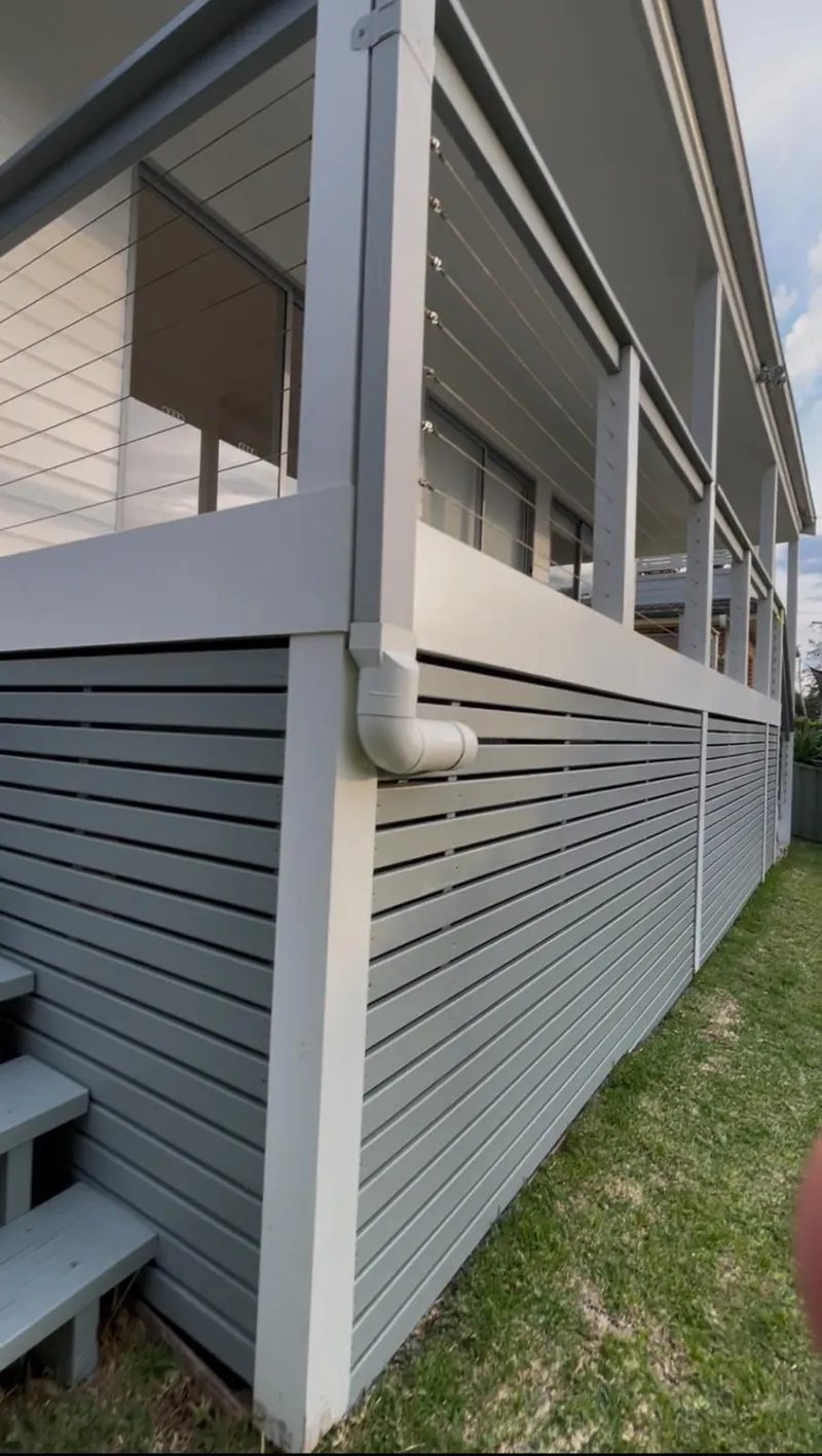 Painted batten screen under a balcony