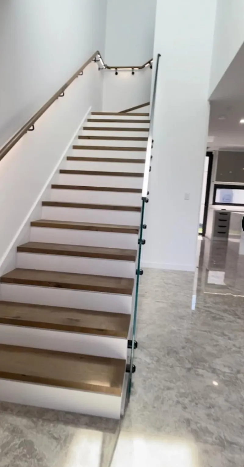 Timber staircase with painted white stringers and walls